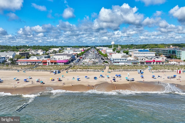 drone / aerial view featuring a water view and a view of the beach