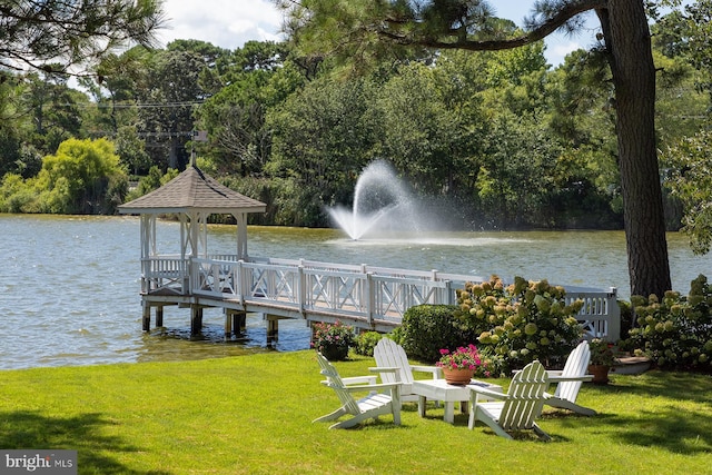 view of dock featuring a yard, a water view, and a gazebo