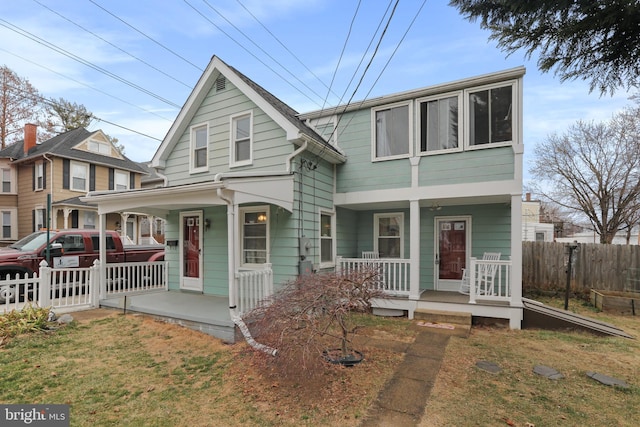 view of front facade featuring covered porch and fence