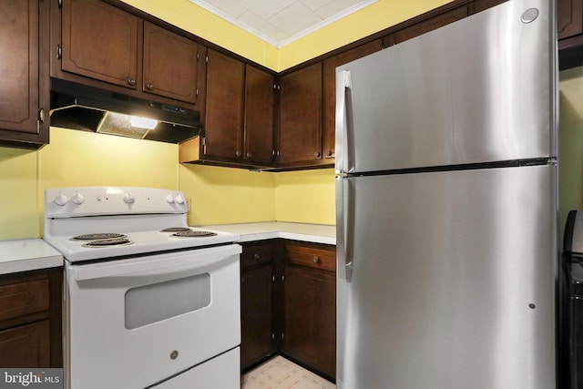 kitchen featuring electric stove, ornamental molding, freestanding refrigerator, light countertops, and under cabinet range hood