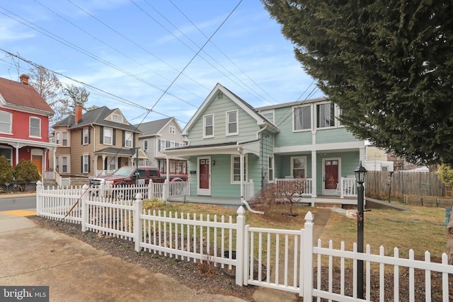 view of front of home with a porch and a fenced front yard