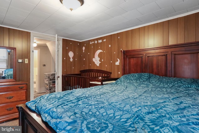 bedroom featuring wooden walls