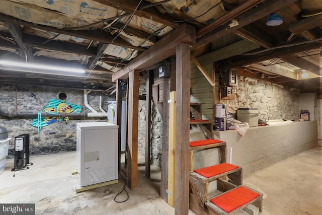 unfinished basement featuring fridge