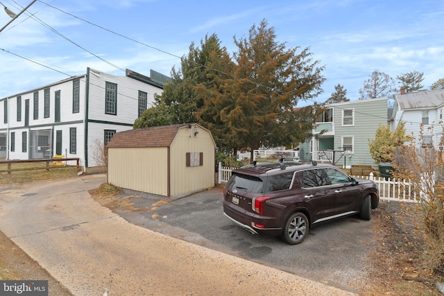 exterior space featuring fence and a shed