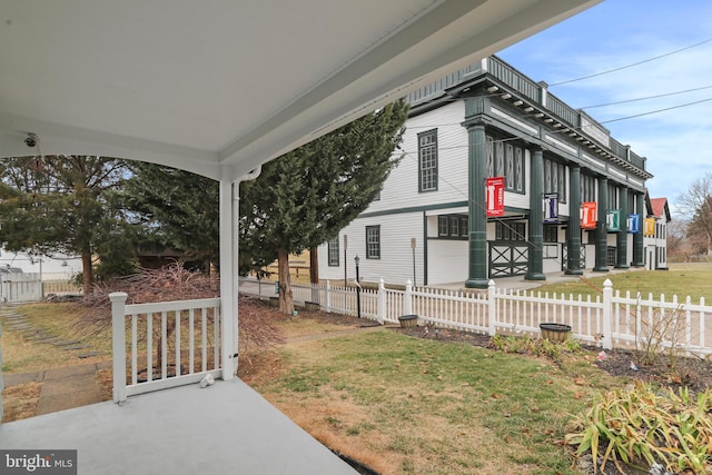 view of side of home featuring a yard and fence