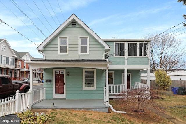 view of front of house with fence and a porch