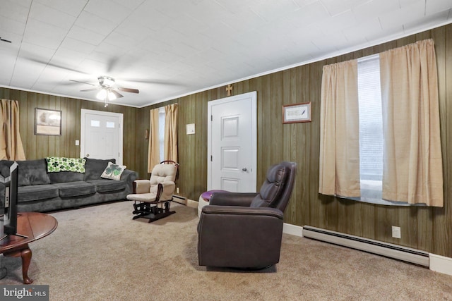 living room with a baseboard heating unit, carpet floors, ceiling fan, and wooden walls