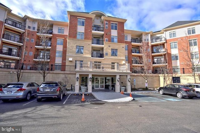 view of building exterior featuring uncovered parking