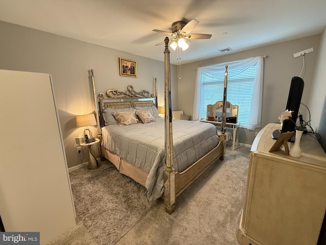 bedroom featuring light carpet, ceiling fan, visible vents, and baseboards