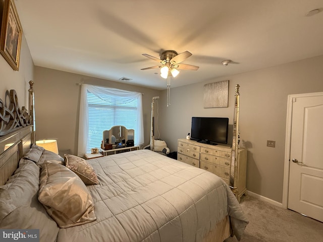 bedroom with light colored carpet, ceiling fan, visible vents, and baseboards