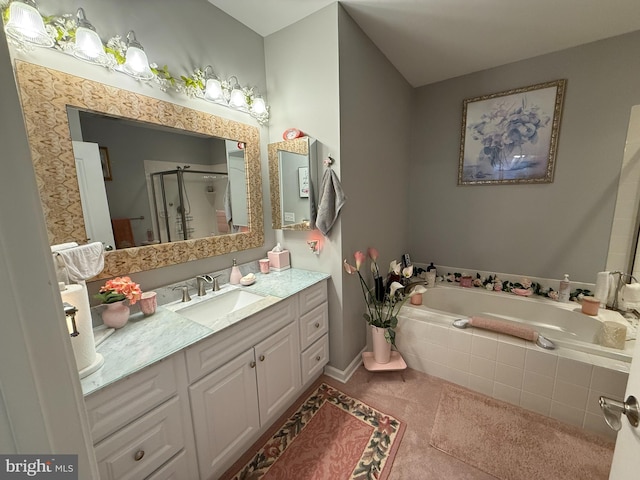 full bath with a stall shower, a garden tub, and vanity