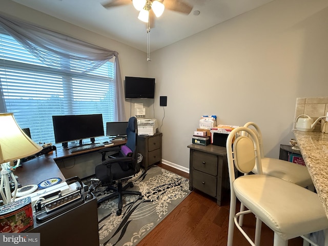 office space featuring ceiling fan, baseboards, and wood finished floors