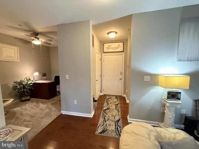 foyer entrance with a ceiling fan, baseboards, and wood finished floors