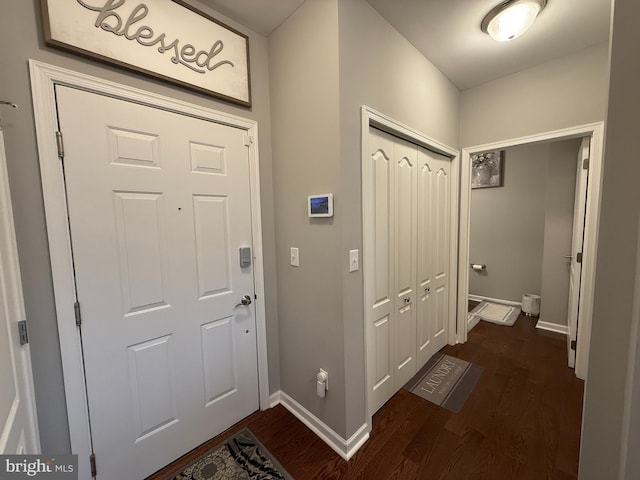 doorway to outside featuring dark wood-style floors and baseboards