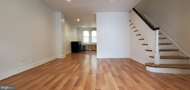 interior space with stairs, recessed lighting, light wood-type flooring, and baseboards