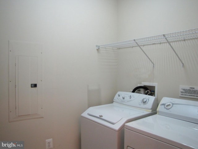 washroom with laundry area, electric panel, and washing machine and clothes dryer