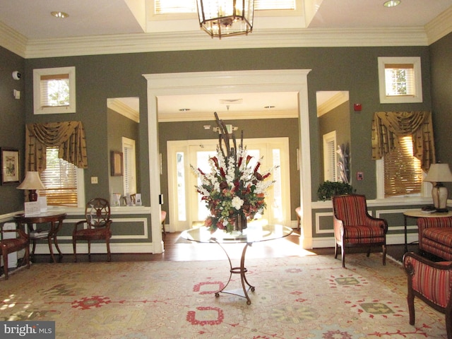 interior space featuring ornamental molding and a notable chandelier