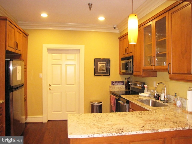 kitchen with a sink, ornamental molding, appliances with stainless steel finishes, light stone countertops, and brown cabinetry