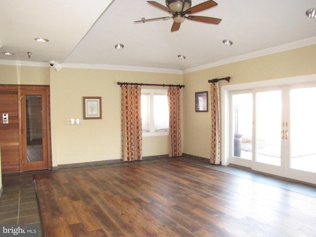 empty room featuring baseboards, wood finished floors, crown molding, and french doors