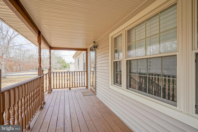 wooden terrace featuring covered porch