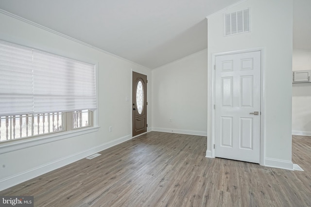 foyer featuring baseboards, visible vents, and wood finished floors