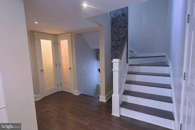 staircase featuring recessed lighting, baseboards, and wood finished floors