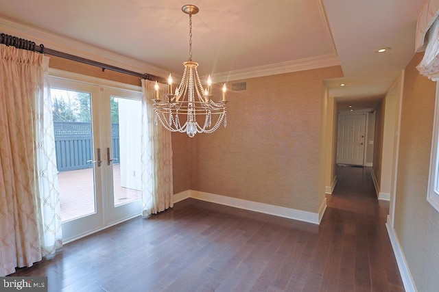 unfurnished dining area featuring dark wood finished floors, visible vents, baseboards, and ornamental molding