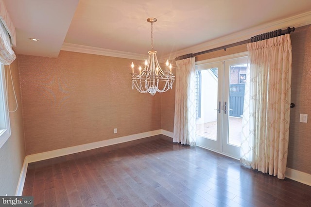 empty room featuring french doors, dark wood-type flooring, baseboards, and crown molding