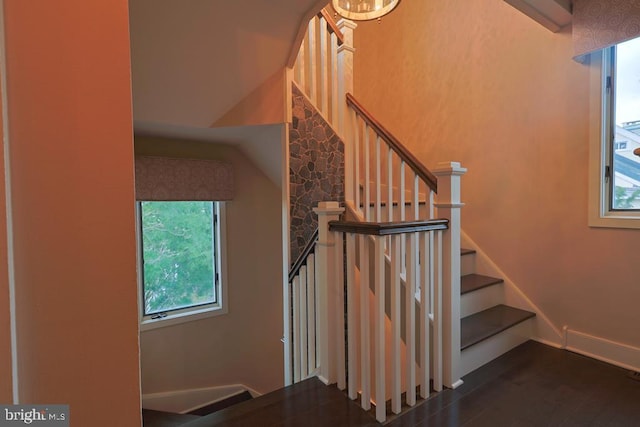 staircase featuring baseboards and wood finished floors