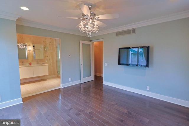 unfurnished bedroom featuring visible vents, ornamental molding, wood finished floors, connected bathroom, and baseboards