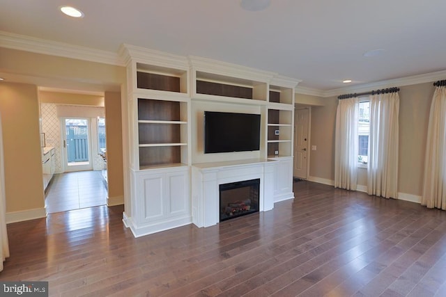 unfurnished living room featuring a glass covered fireplace, crown molding, baseboards, and dark wood-style flooring