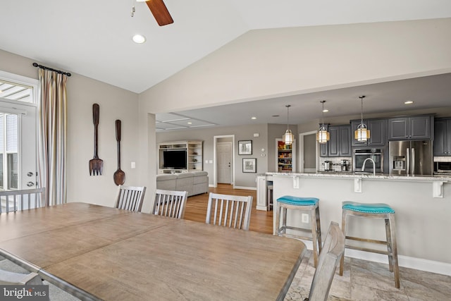 dining room with lofted ceiling, recessed lighting, baseboards, and ceiling fan