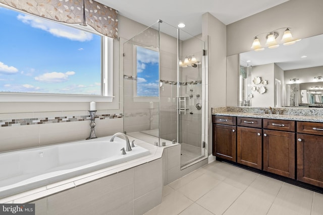 bathroom with tile patterned flooring, a stall shower, vanity, and a garden tub