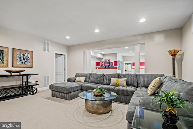 living room featuring recessed lighting, visible vents, wood finished floors, and ornate columns