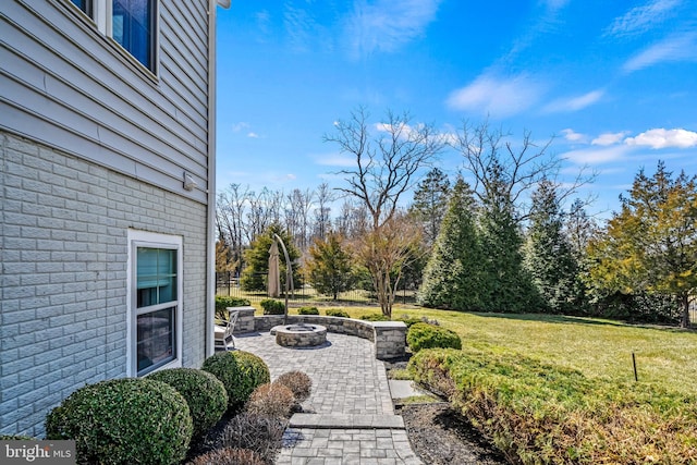 view of yard featuring a patio and a fire pit