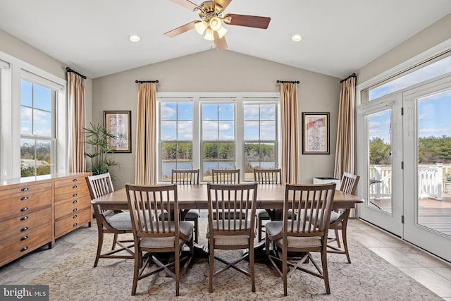 dining area with lofted ceiling, light tile patterned floors, recessed lighting, and a wealth of natural light