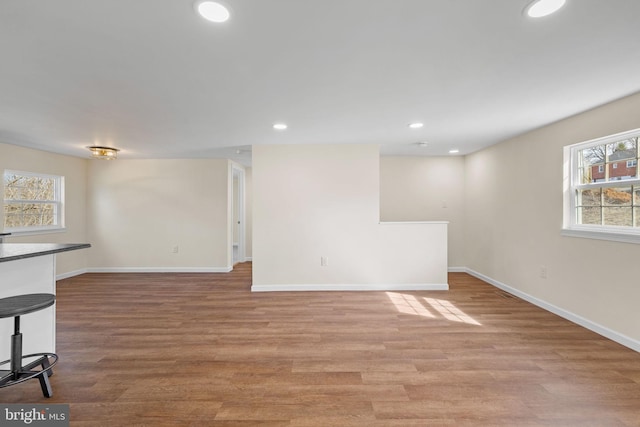 interior space with recessed lighting, a healthy amount of sunlight, baseboards, and light wood-style floors