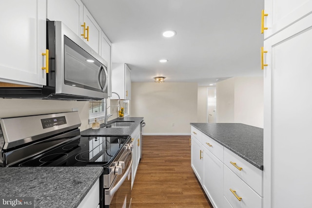 kitchen with recessed lighting, dark wood-style floors, appliances with stainless steel finishes, and white cabinets