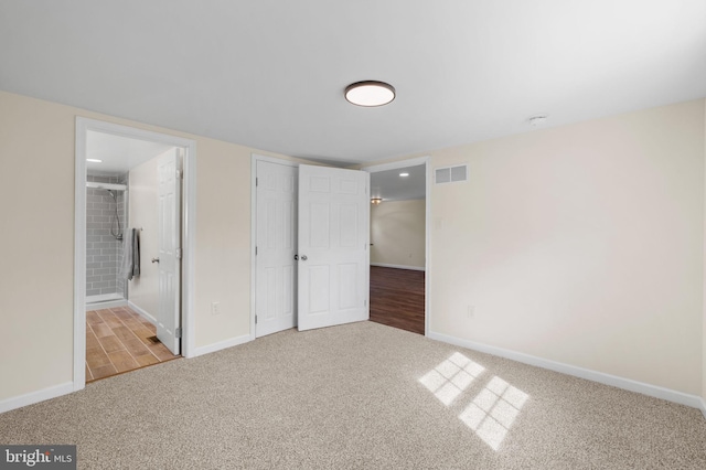 unfurnished bedroom featuring carpet flooring, baseboards, and visible vents