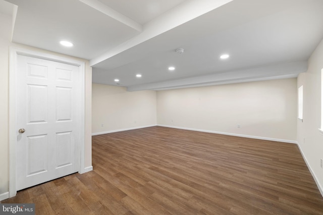 finished below grade area featuring recessed lighting, wood finished floors, and baseboards