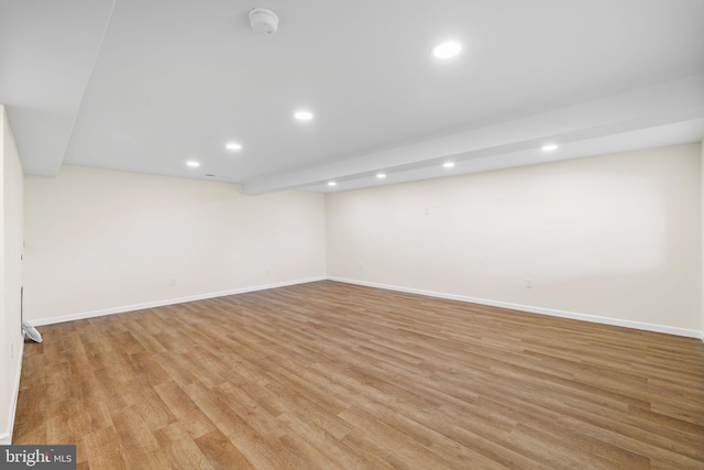 finished below grade area with recessed lighting, baseboards, and light wood finished floors