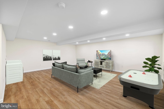 living room with recessed lighting, baseboards, and light wood-style flooring