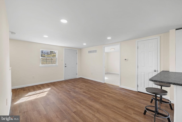 interior space with visible vents, recessed lighting, baseboards, and wood finished floors