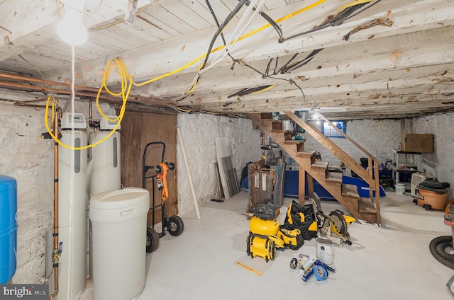 unfinished basement featuring stairs