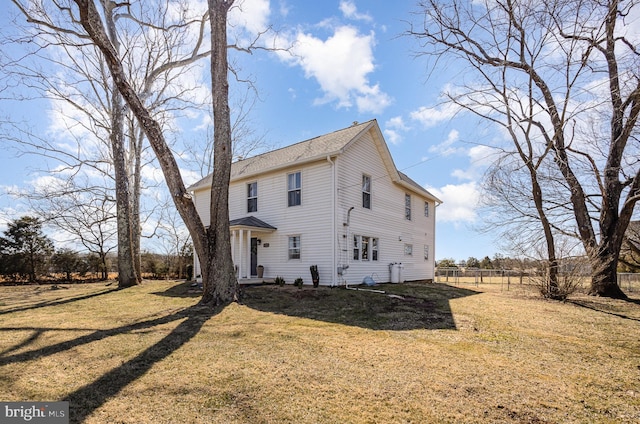 view of front of house featuring a front yard and fence