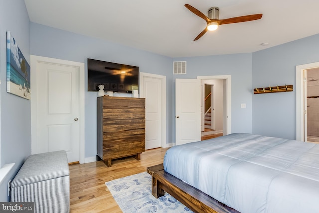 bedroom with visible vents, baseboards, connected bathroom, ceiling fan, and light wood-style floors