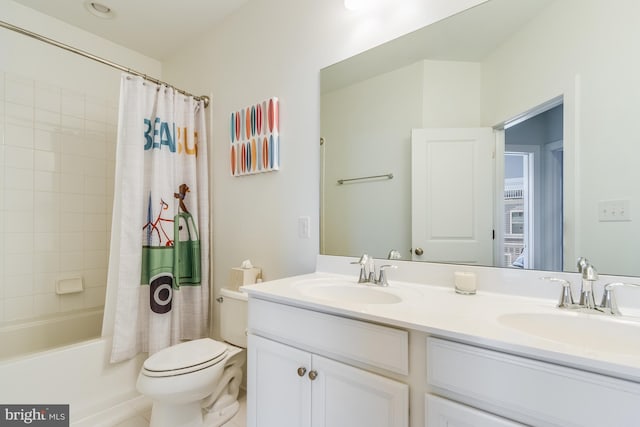 bathroom featuring a sink, toilet, and double vanity