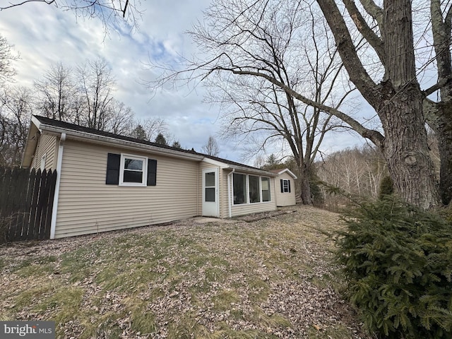 back of house with fence