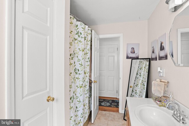 full bathroom featuring tile patterned flooring and vanity
