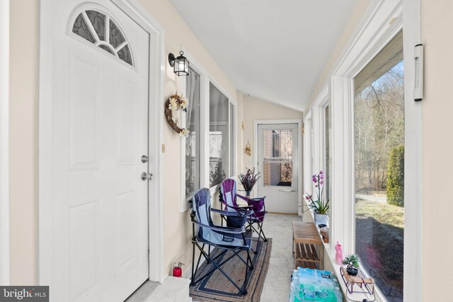sunroom / solarium featuring lofted ceiling